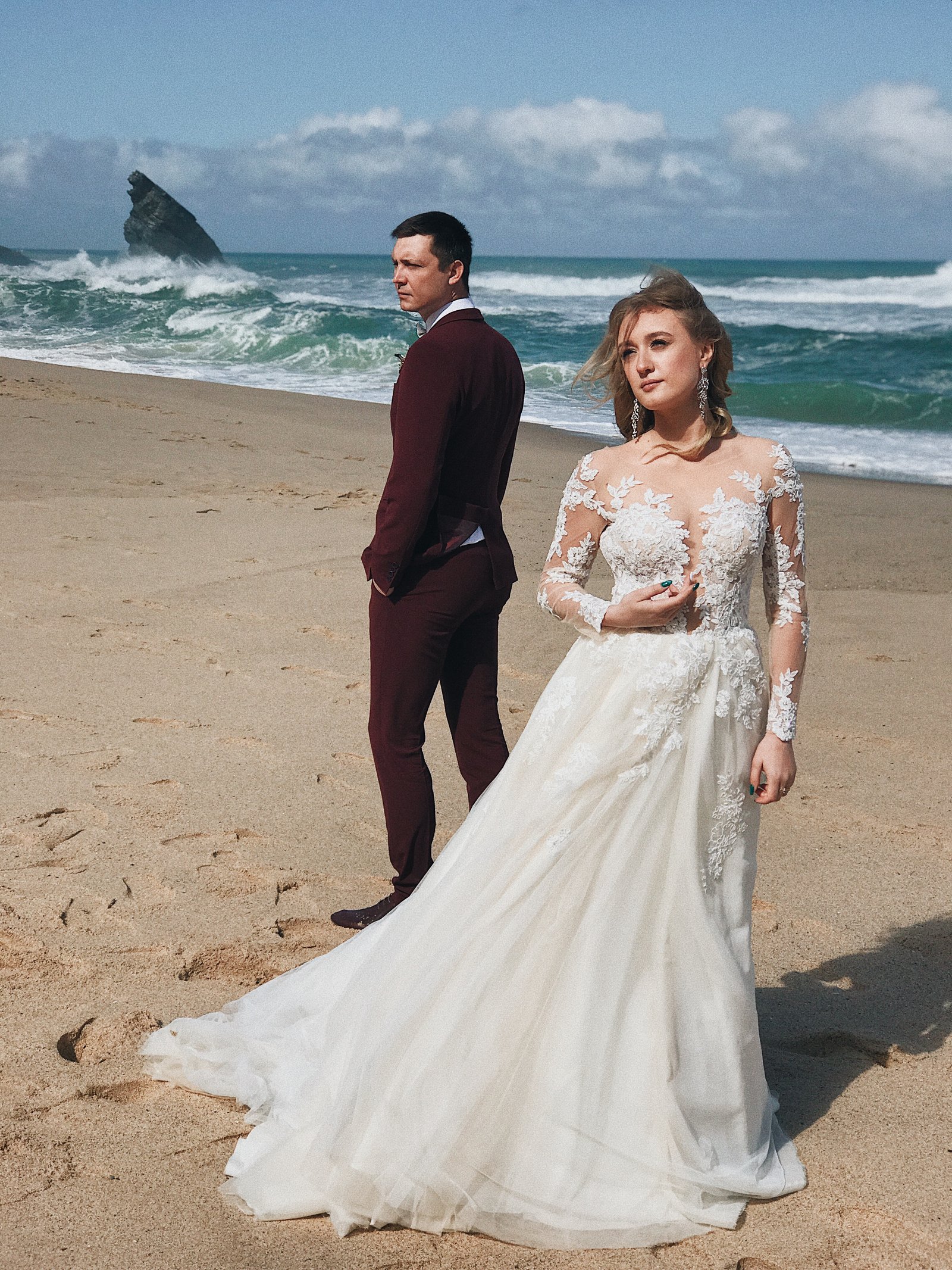 A couple together by the sea on their wedding day